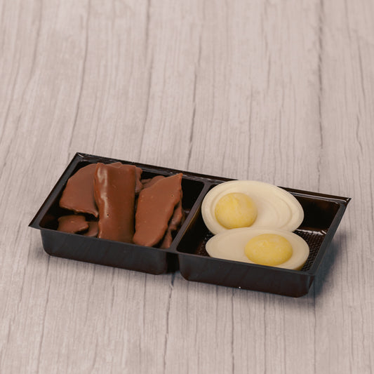 Milk chocolate covered bacon (real bacon- crispy!) and white and yellow coating deviled eggs packaged together for breakfast!!!