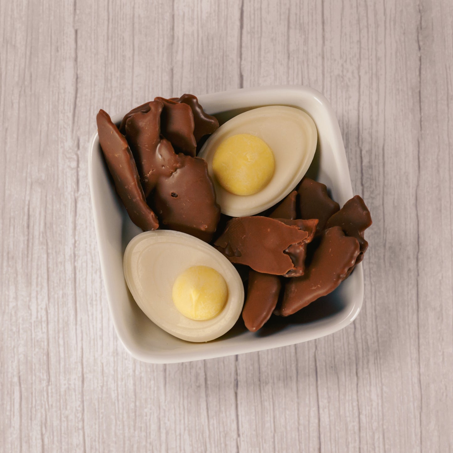Milk chocolate covered bacon (real bacon- crispy!) and white and yellow coating deviled eggs packaged together for breakfast!!!