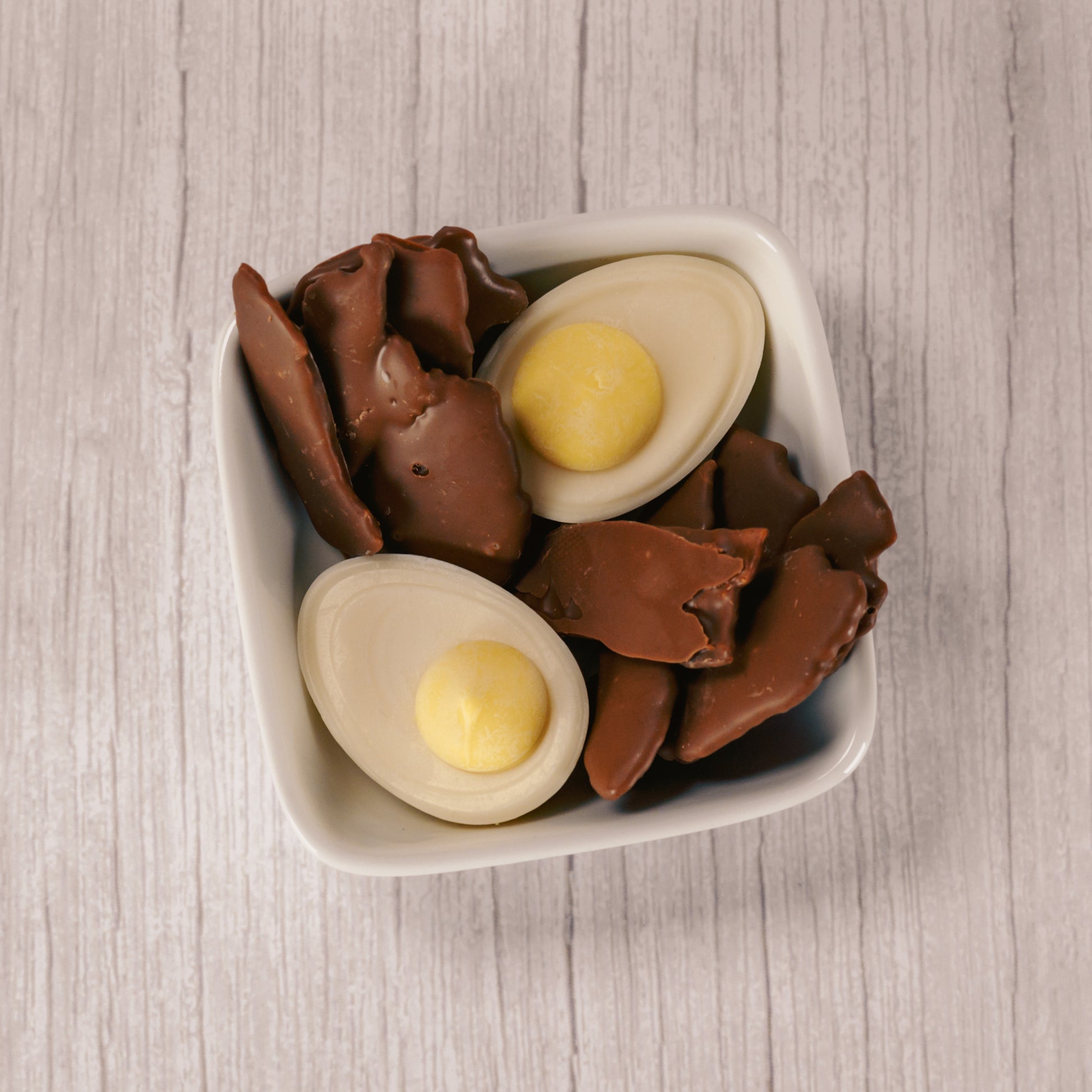 Milk chocolate covered bacon (real bacon- crispy!) and white and yellow coating deviled eggs packaged together for breakfast!!!