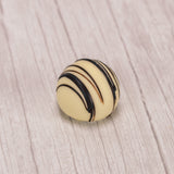 white chocolate amaretto truffle with dark chocolate drizzle icing on top