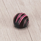 dark chocolate raspberry truffle with pink drizzle icing on top