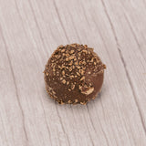 milk chocolate truffle with milk chocolate sprinkles on top