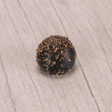 dark chocolate truffle with dark chocolate sprinkles on top