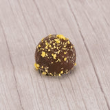 milk chocolate lemon truffle with yellow sprinkles on top