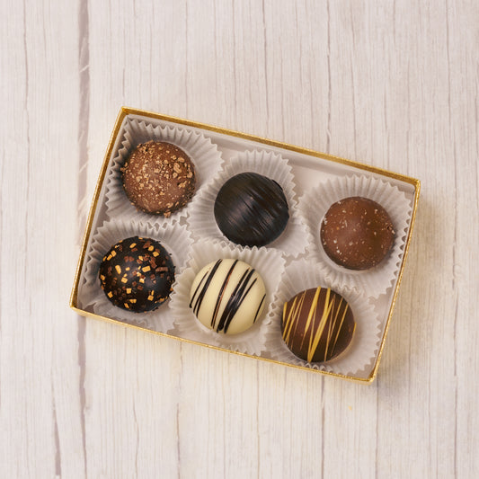 pretty truffles in a six piece box.