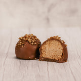 Marie's truffles made only five times a year that are made with cream and butter and have a mouse fluffy center. A box of 12, chocolate with crushed pecans