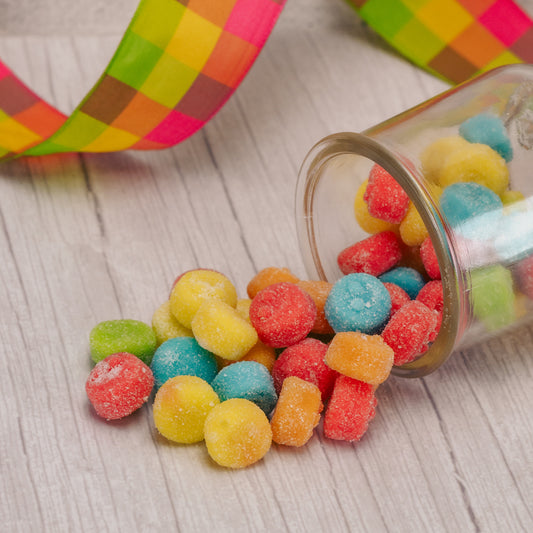 soft, small and round bite-sized colorful sour poppers in a half pound bag