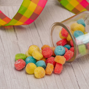 soft, small and round bite-sized colorful sour poppers in a half pound bag