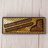 a pair or snow skis and a boot in smooth milk chocolate. comes packaged in a box with a clear lid.