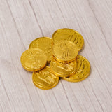 a small 1 oz. mesh bag is filled with milk chocolate foil wrapped gold coins.