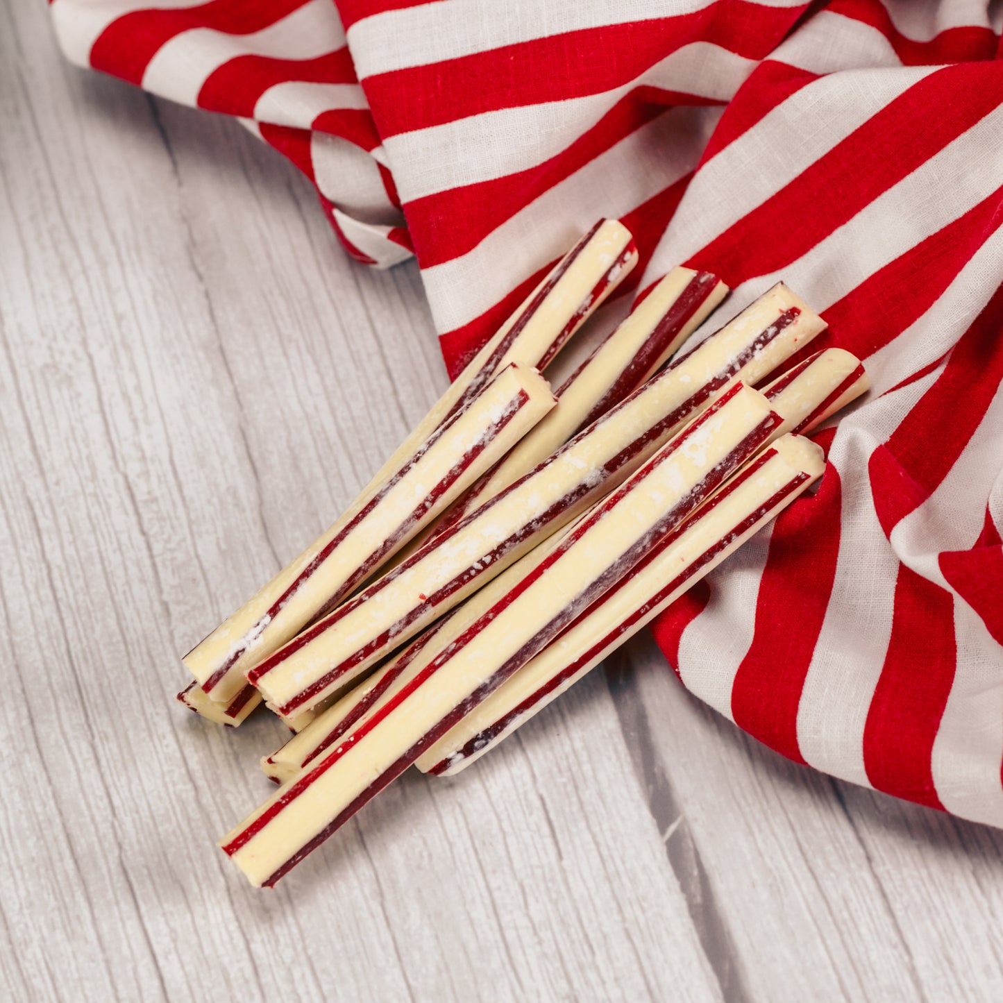Red and white striped peppermint stirrers for hot cocoa or coffee.