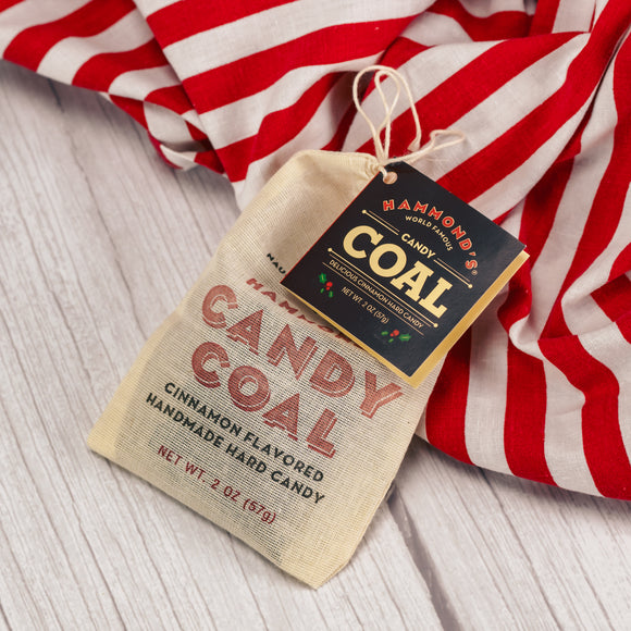 a small bag of candy coal - flavored cinnamon hard candy to look like coal.