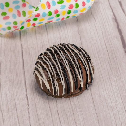 1/4 lb. milk chocolate egg filled with cookies n cream center, drizzled with dark chocolate and white coating and sprinkled with oreo cookie crumbs.