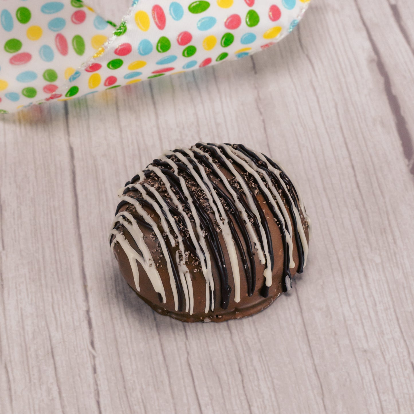 1/4 lb. milk chocolate egg filled with cookies n cream center, drizzled with dark chocolate and white coating and sprinkled with oreo cookie crumbs.