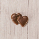 milk chocolate double heart placed in a clear cello bag and sealed. Perfect for a party favor. Bite-sized.