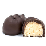 coconut cream with shreds of coconut pieces covered in rich dark chocolate in a pound box.