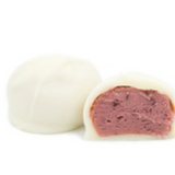 Raspberry puree cream center dipped in sweet white coating (like white chocolate) in a pound box.